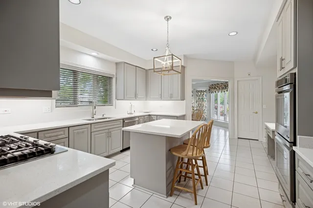 a kitchen with a sink stove and refrigerator