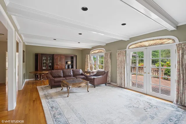 a living room with furniture and large windows
