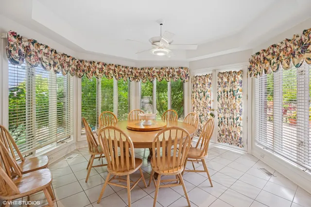 a view of a dining room with furniture large windows and wooden floor