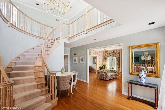 a view of a livingroom with furniture staircase windows and wooden floor