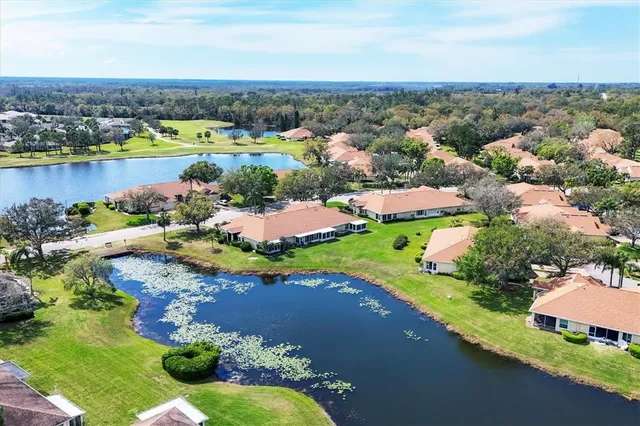 an aerial view of a city with lots of residential buildings lake and ocean view