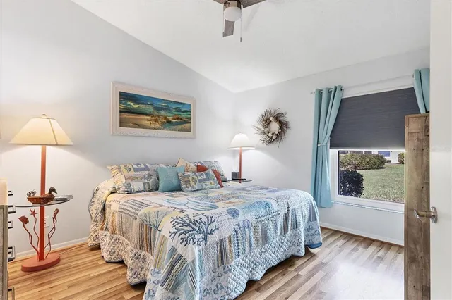 a bedroom with a bed and a painting on the wall