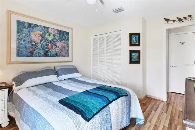 a bedroom with a bed and a painting on the wall