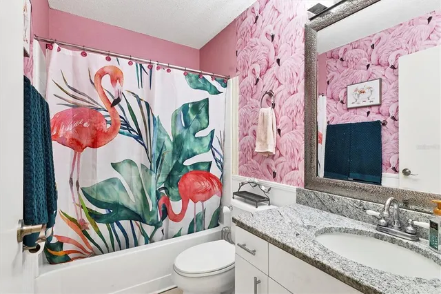 a bathroom with a sink and a mirror with painted walls