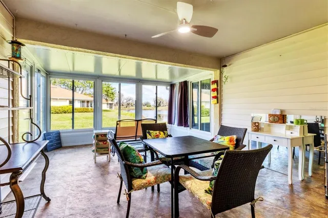 a dining room with furniture a chandelier and wooden floor