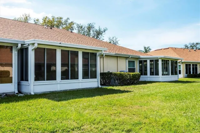 a view of a house with a yard and sitting area