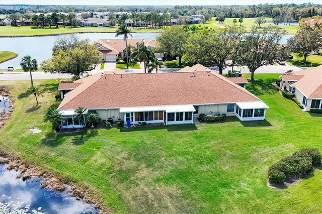 an aerial view of house with yard and lake view