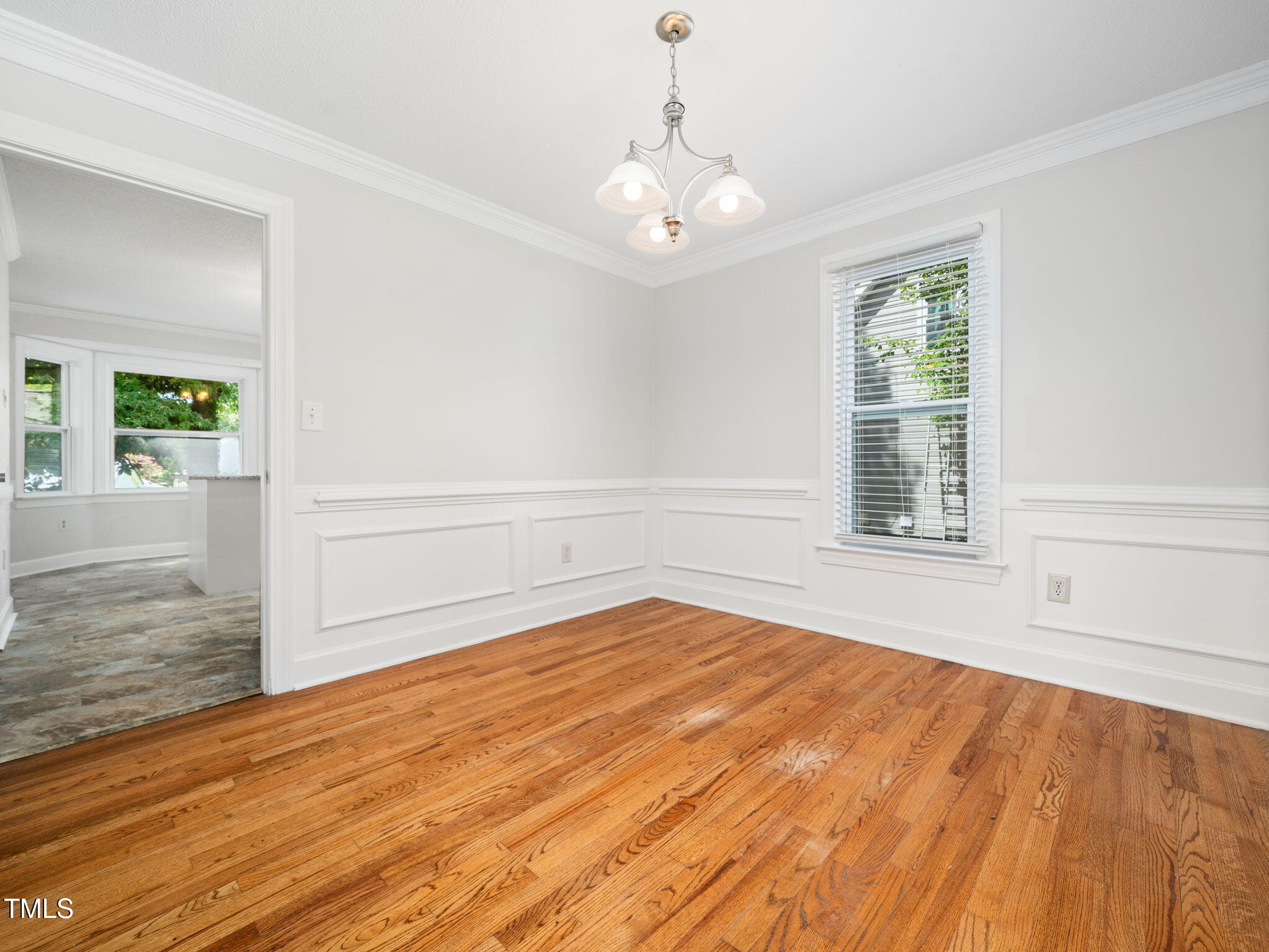 3909 Iron Horse Road Raleigh, NC 27616 - Photo 14 of 47 a view of an empty room with wooden floor and a window