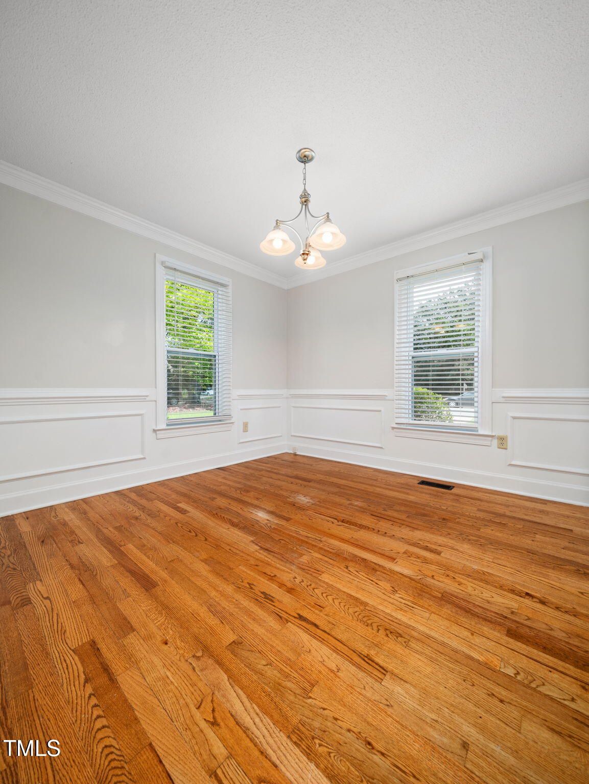 3909 Iron Horse Road Raleigh, NC 27616 - Photo 16 of 47 an empty room with wooden floor and windows