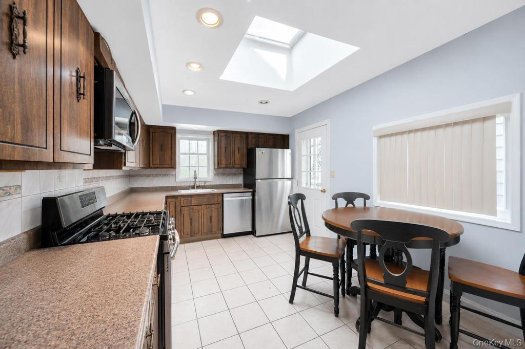 89-13 84th Street Queens, NY 11421 - Photo 17 of 34 Kitchen featuring a skylight, recessed lighting, and tile flooring