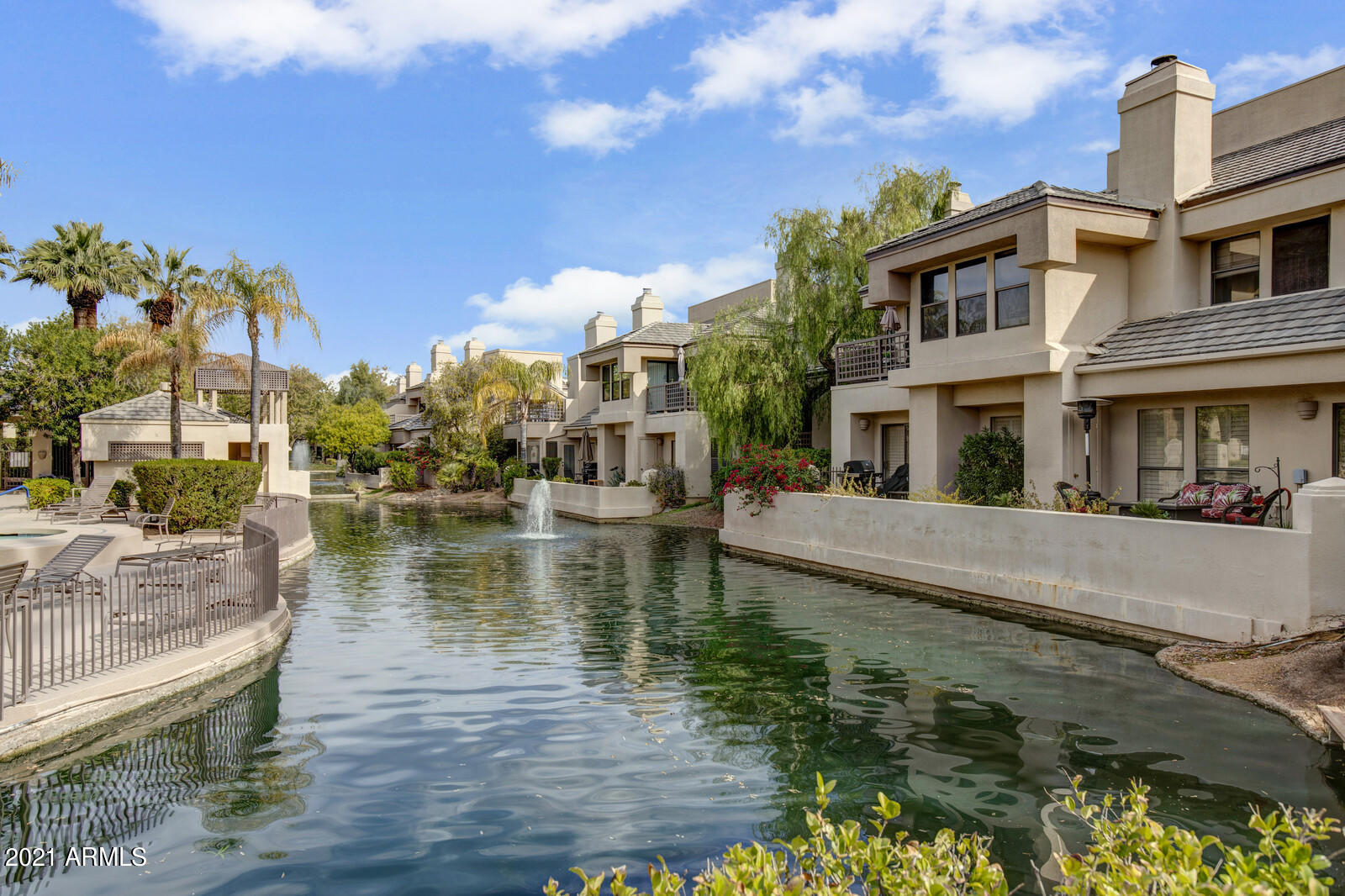 7272 East Gainey Ranch Road, Unit 85 Scottsdale, AZ 85258 - Photo 1 of 37 a view of a lake with a house