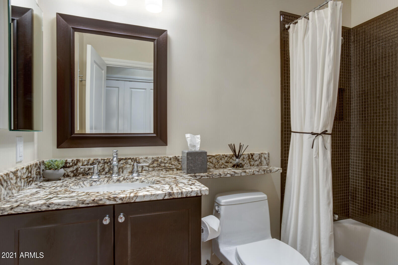 7272 East Gainey Ranch Road, Unit 85 Scottsdale, AZ 85258 - Photo 21 of 37 a bathroom with a granite countertop sink toilet and mirror