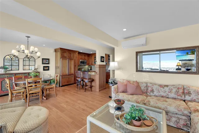 a living room with furniture and a dining table with kitchen view