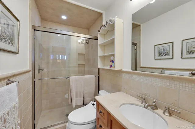 a bathroom with a sink toilet and shower
