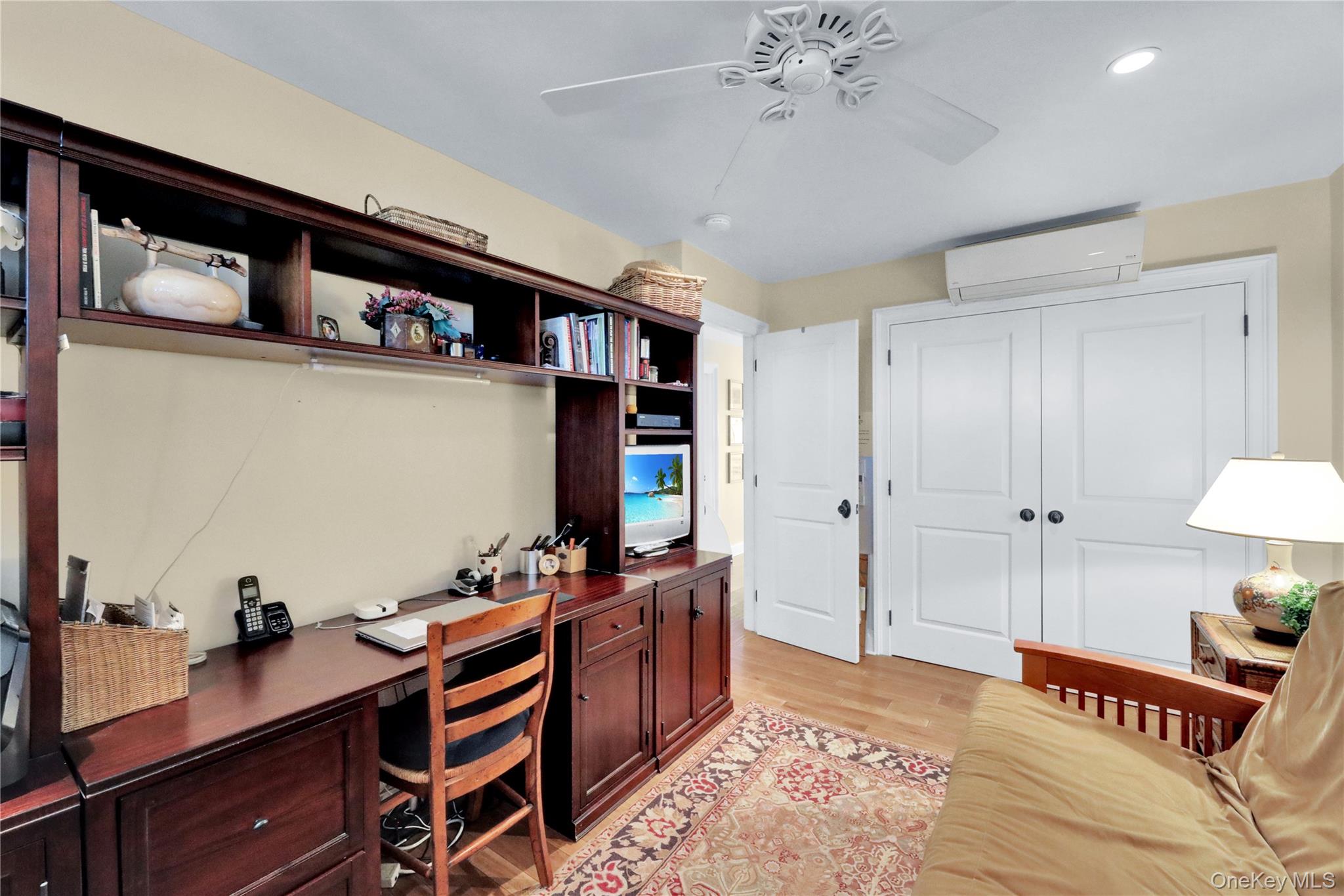 279 Dune Road, Unit 2 Westhampton Beach, NY 11978 - Photo 28 of 45 a bedroom with furniture and a flat screen tv