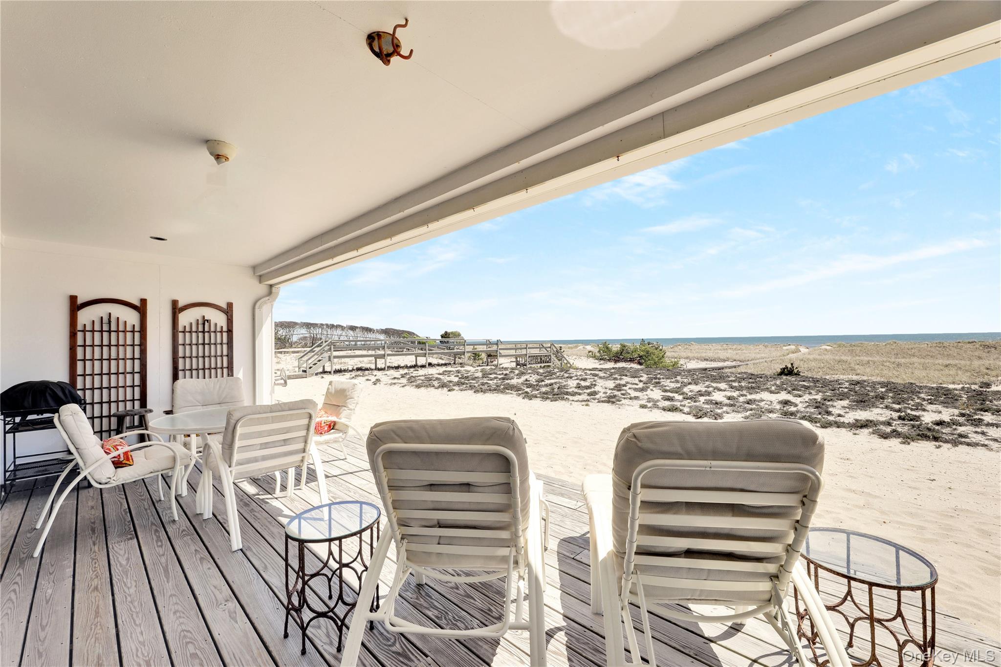 279 Dune Road, Unit 2 Westhampton Beach, NY 11978 - Photo 30 of 45 a view of a city from a balcony with furniture