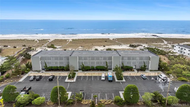 a view of swimming pool with outdoor seating and ocean view
