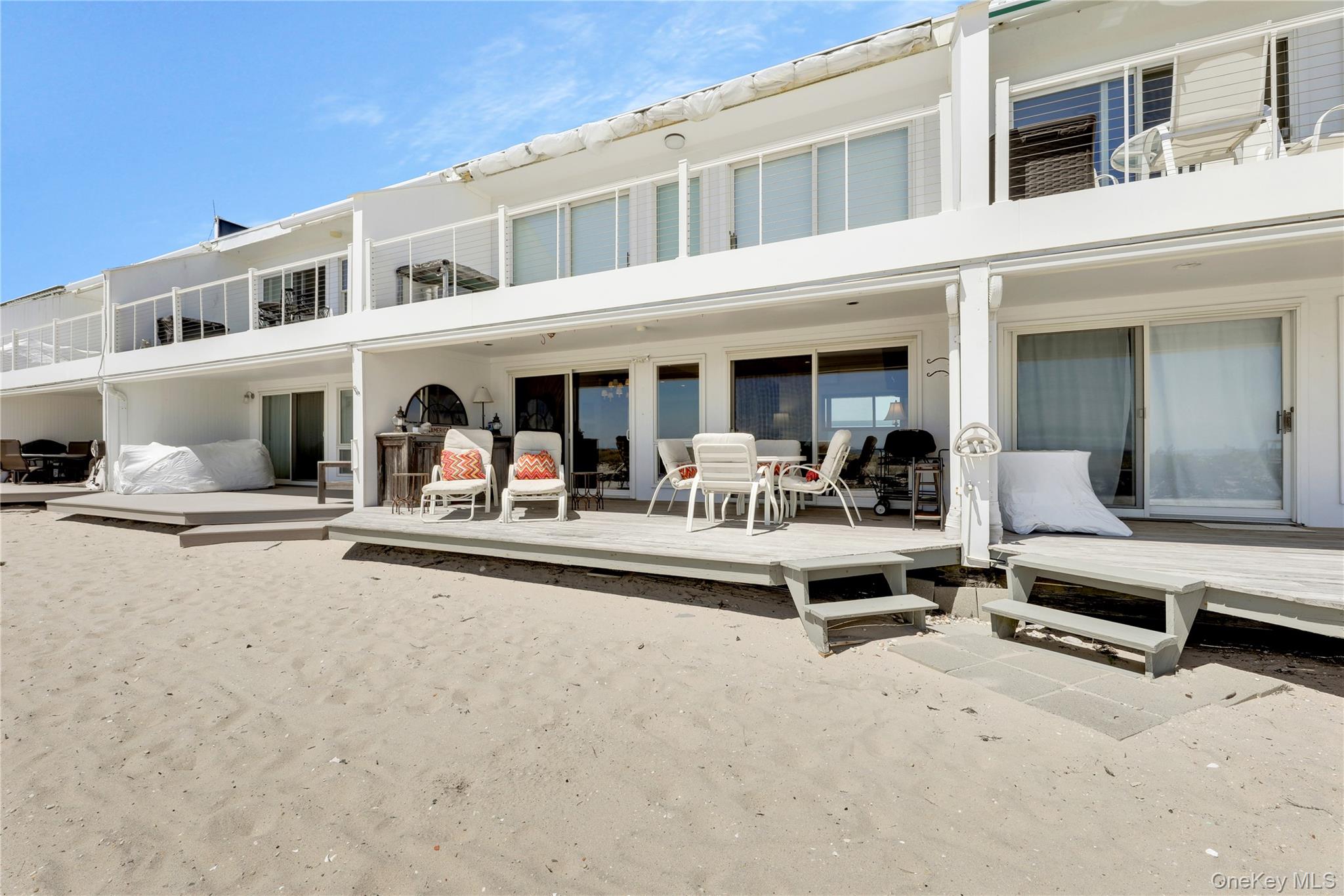 279 Dune Road, Unit 2 Westhampton Beach, NY 11978 - Photo 31 of 45 a view of a building with sitting area