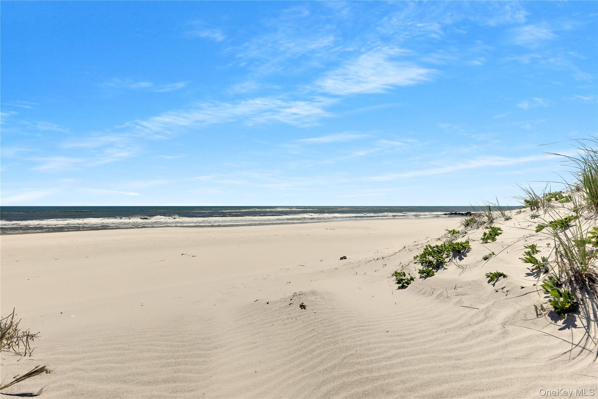 279 Dune Road, Unit 2 Westhampton Beach, NY 11978 - Photo 35 of 45 a view of an ocean beach
