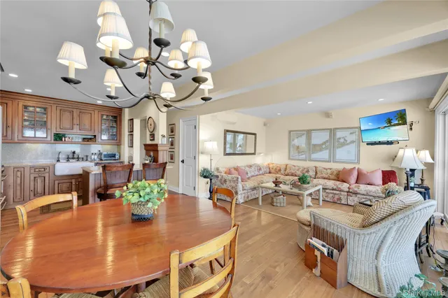 a living room with fireplace furniture and a chandelier