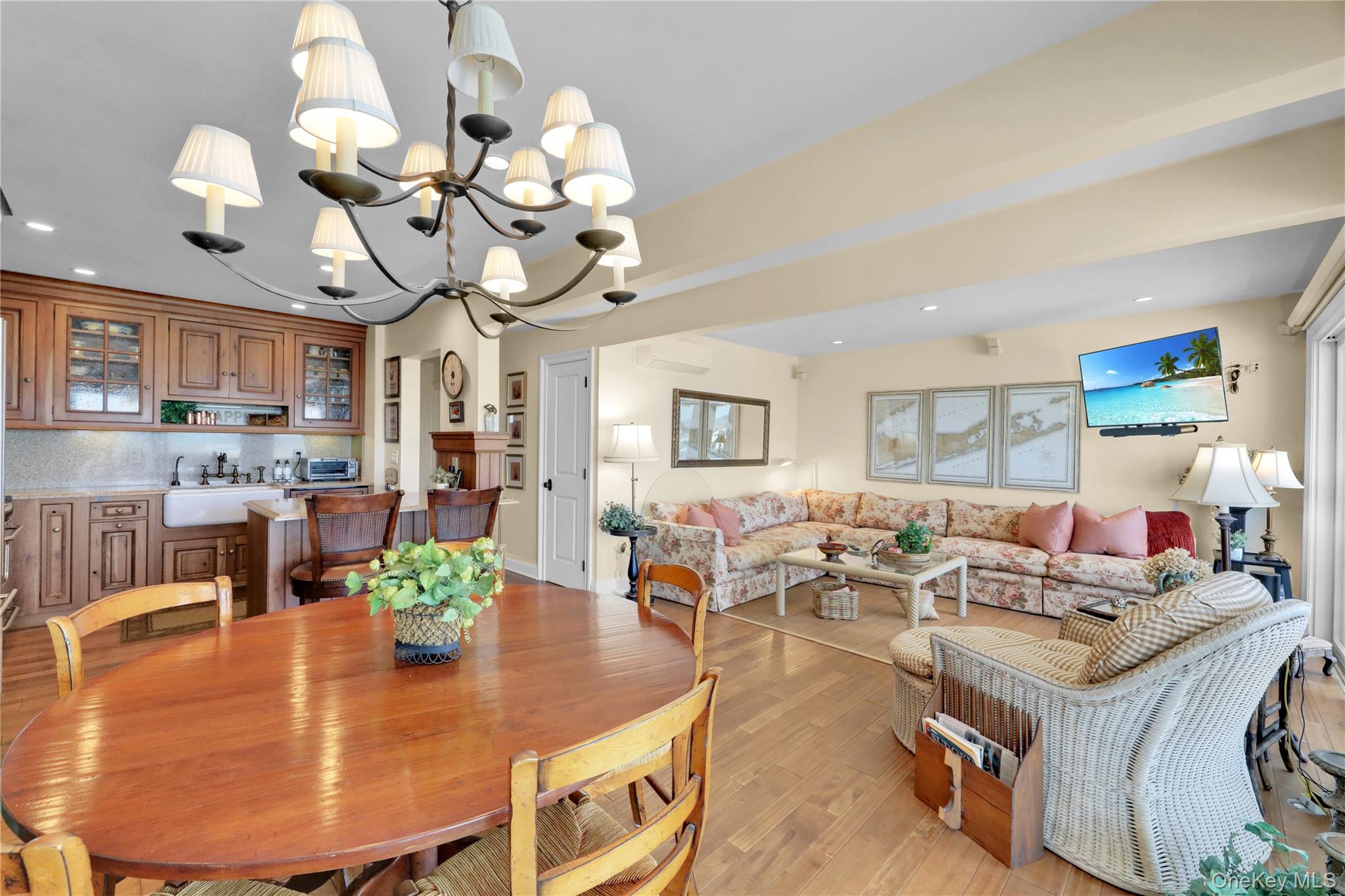 279 Dune Road, Unit 2 Westhampton Beach, NY 11978 - Photo 8 of 45 a living room with fireplace furniture and a chandelier