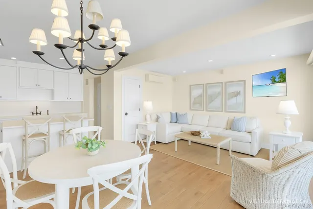 a living room with furniture chandelier and a chandelier