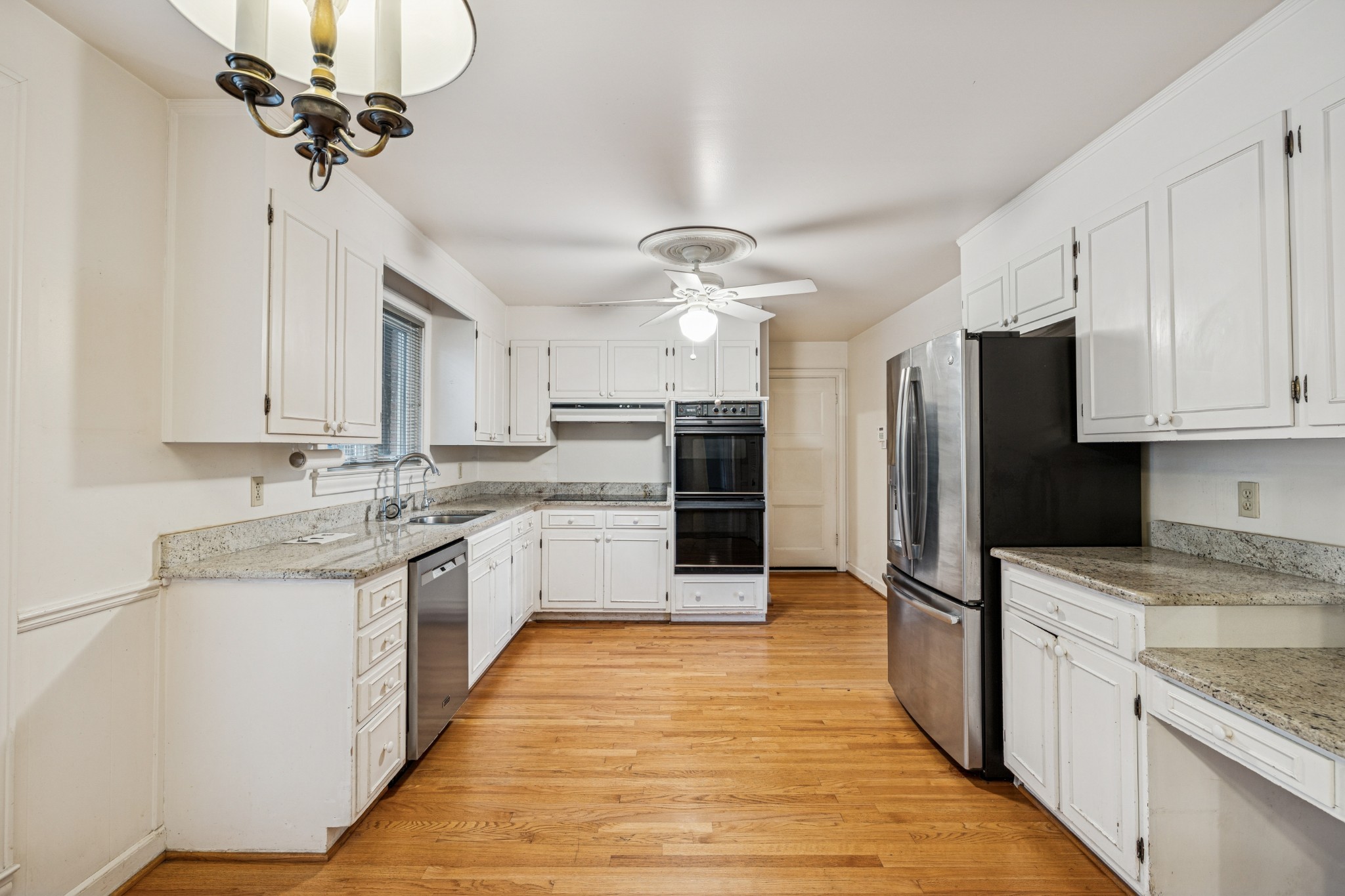 718 Murfreesboro Road Franklin, TN 37064 - Photo 12 of 35 a kitchen with stainless steel appliances granite countertop a refrigerator a sink a stove and oven with wooden floor