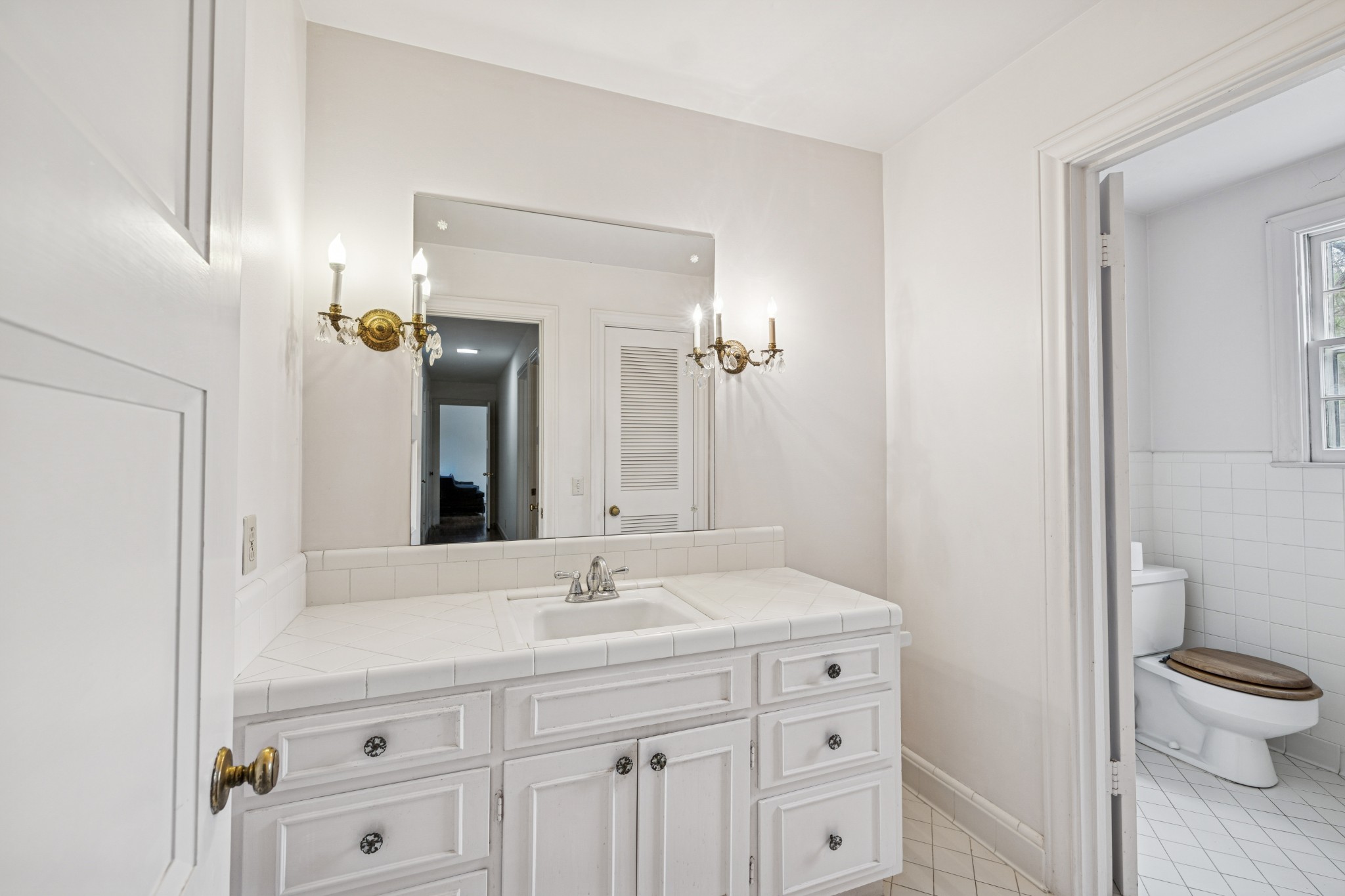 718 Murfreesboro Road Franklin, TN 37064 - Photo 21 of 35 a bathroom with a sink a toilet and a mirror
