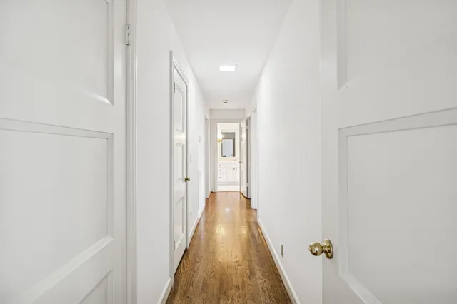 a view of a hallway with wooden floor
