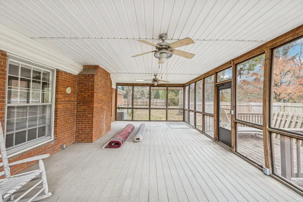 a view of a livingroom with wooden floor and furniture