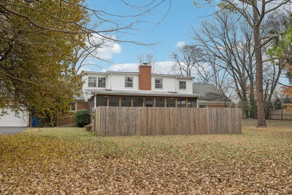 a view of a house with wooden fence