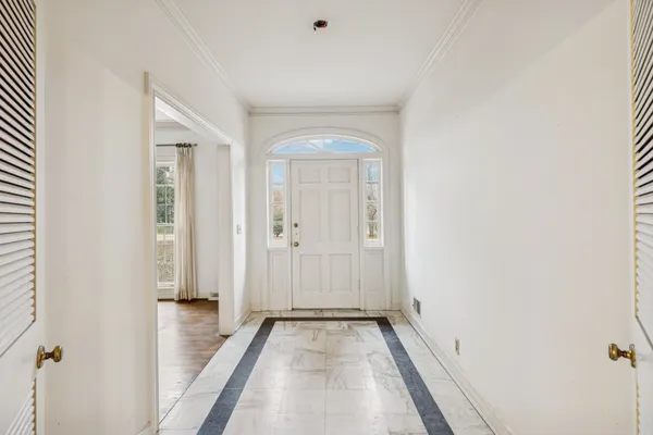 a view of a room with wooden floor and a bathroom