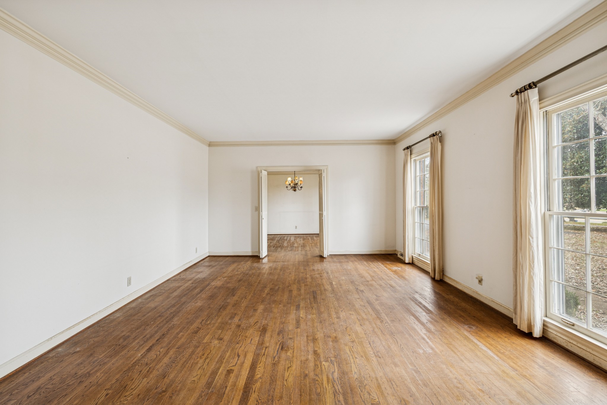 718 Murfreesboro Road Franklin, TN 37064 - Photo 5 of 35 an empty room with wooden floor and windows