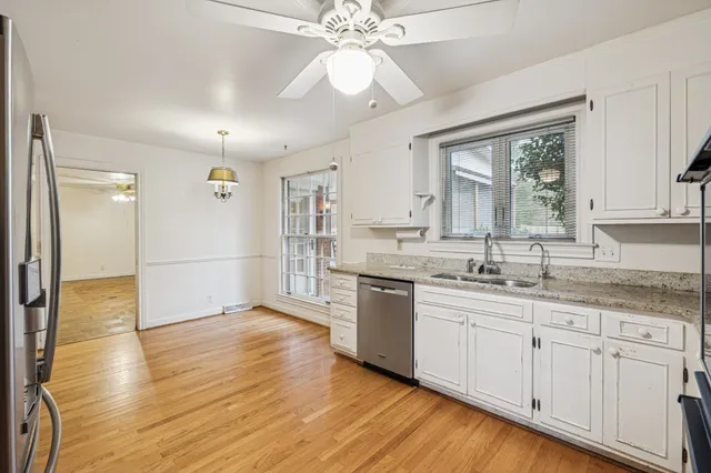 a open kitchen with a sink dishwasher a refrigerator and a oven with wooden floor