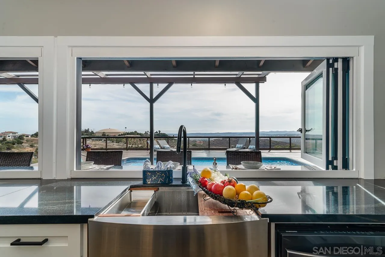 1647 Sleeping Indian Road Fallbrook, CA 92028 - Photo 15 of 48 a kitchen with a large window and a table