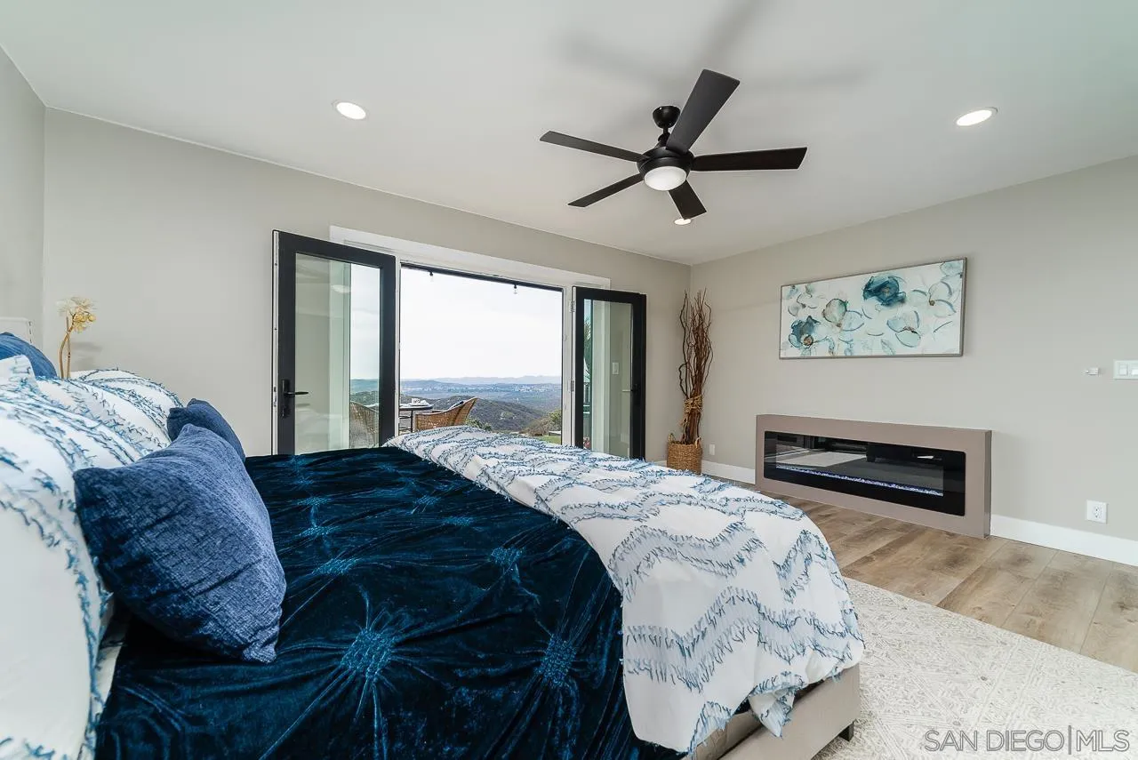 1647 Sleeping Indian Road Fallbrook, CA 92028 - Photo 19 of 48 a bedroom with a large bed and a chandelier