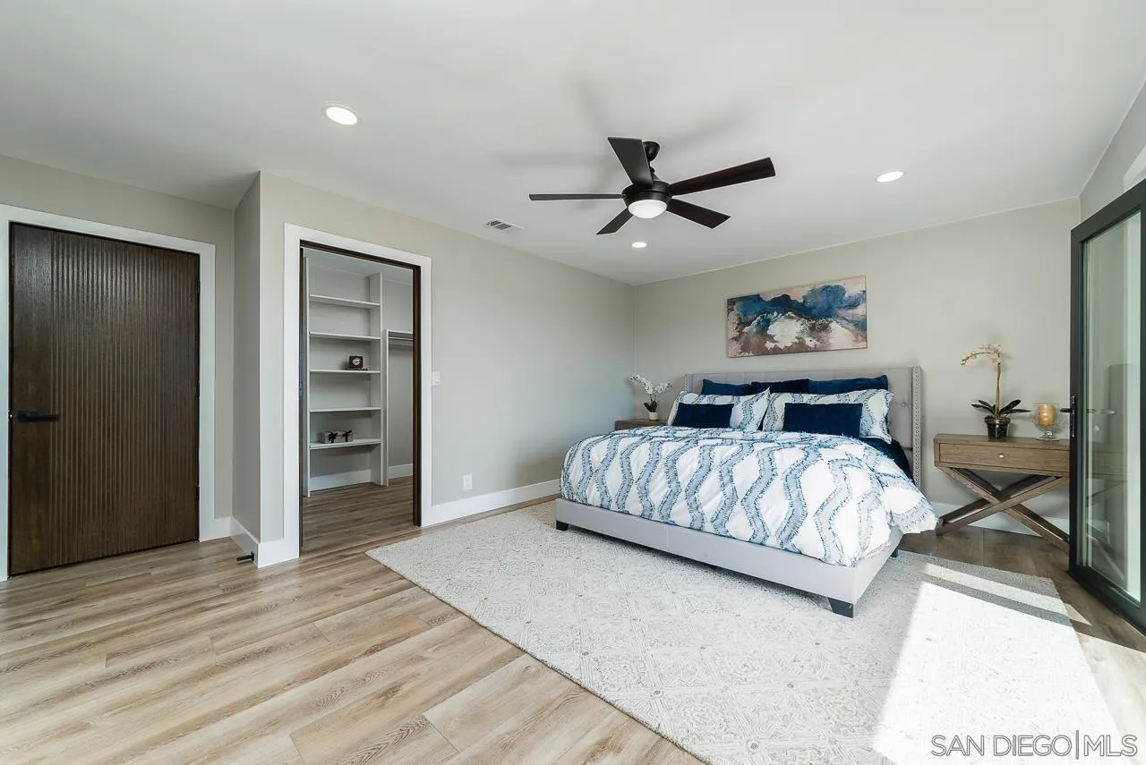 1647 Sleeping Indian Road Fallbrook, CA 92028 - Photo 20 of 48 a bedroom with a large bed and a chandelier