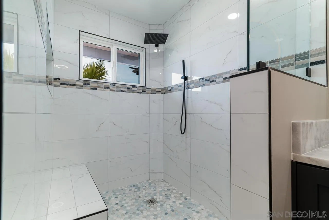 1647 Sleeping Indian Road Fallbrook, CA 92028 - Photo 23 of 48 a bathroom with a shower and a mirror