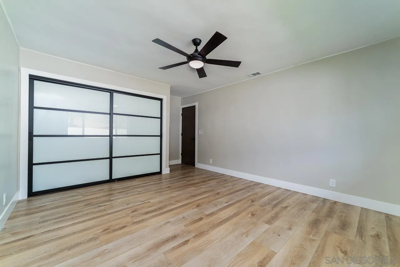 1647 Sleeping Indian Road Fallbrook, CA 92028 - Photo 26 of 48 a view of a room with wooden floor and a ceiling fan