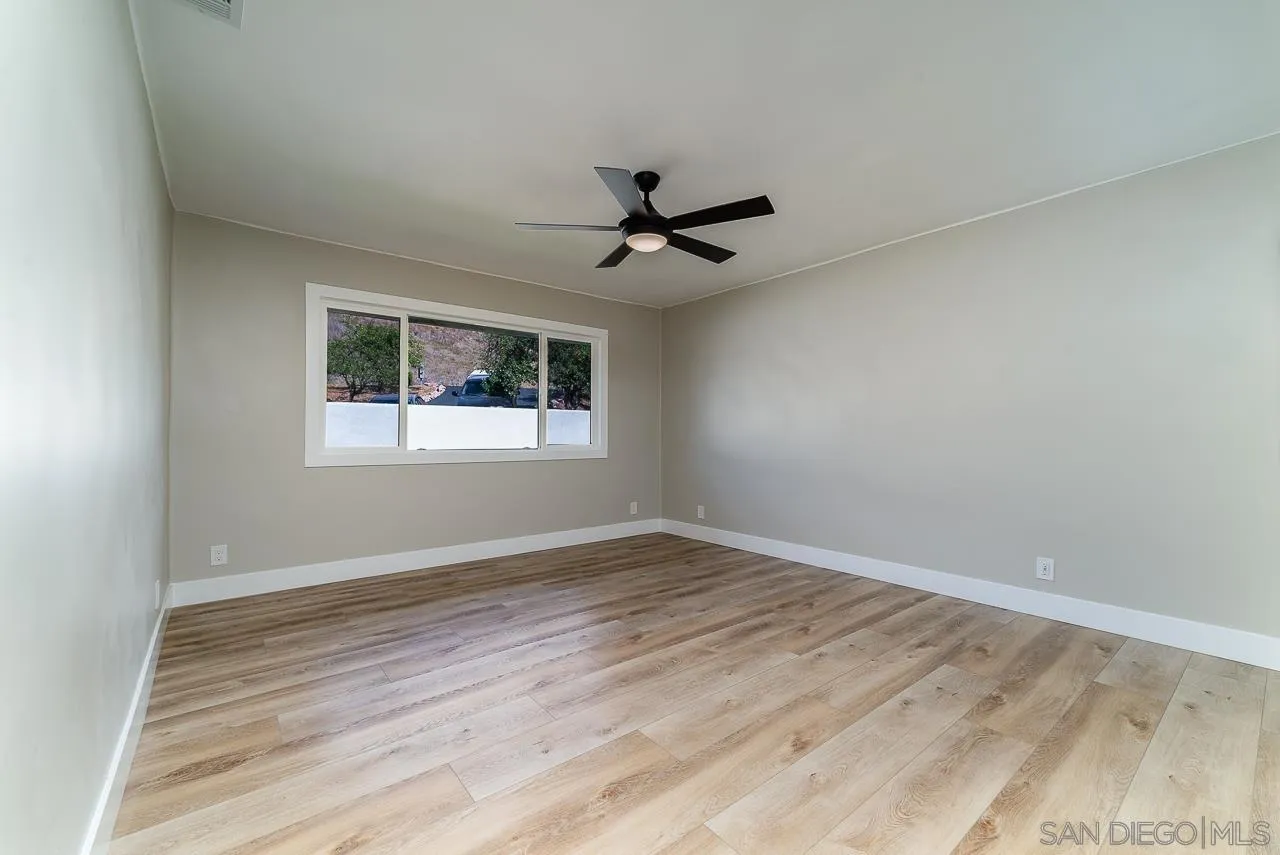 1647 Sleeping Indian Road Fallbrook, CA 92028 - Photo 27 of 48 wooden floor in an empty room with a window
