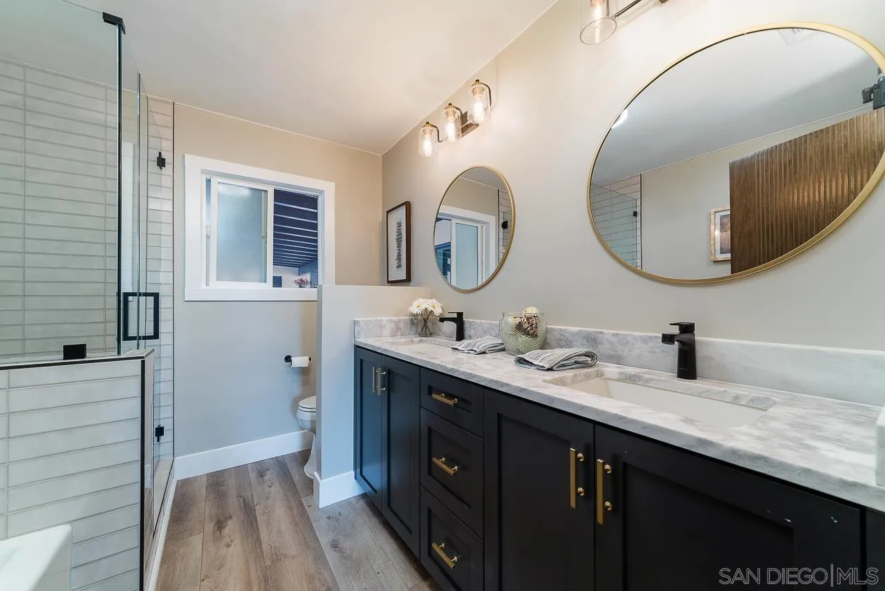 1647 Sleeping Indian Road Fallbrook, CA 92028 - Photo 28 of 48 a bathroom with a double vanity sink and a mirror