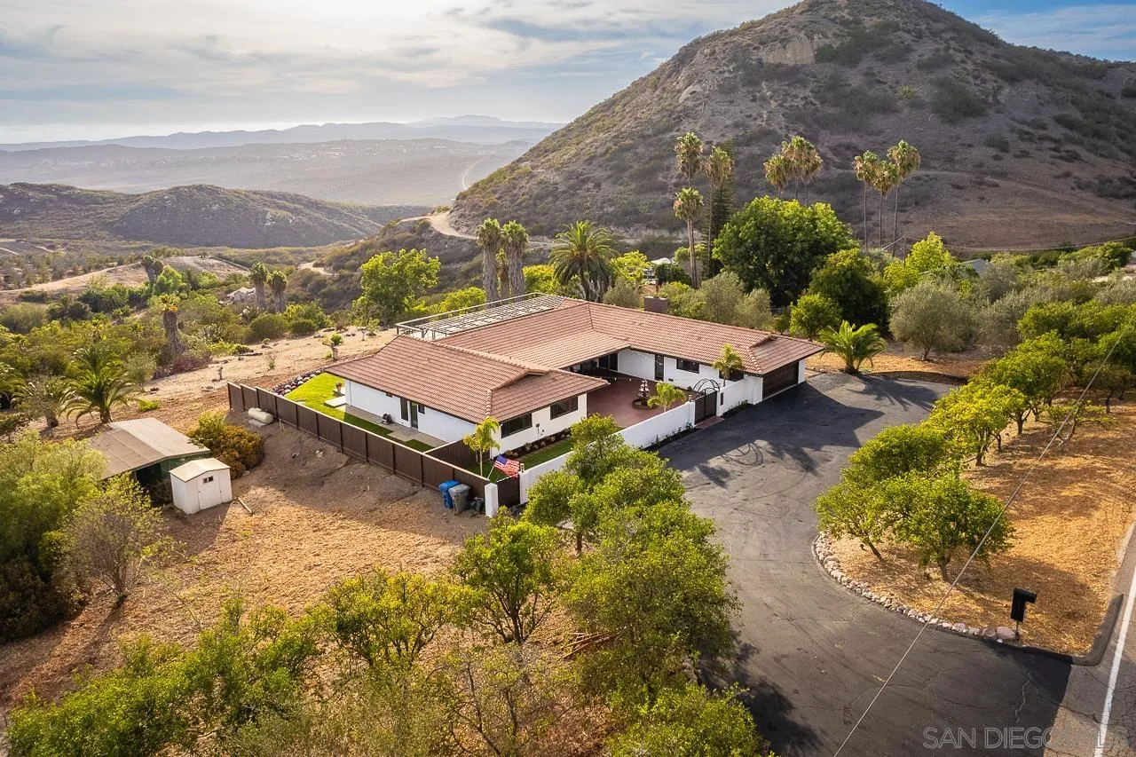 1647 Sleeping Indian Road Fallbrook, CA 92028 - Photo 44 of 48 an aerial view of a house with a garden and mountain view in back