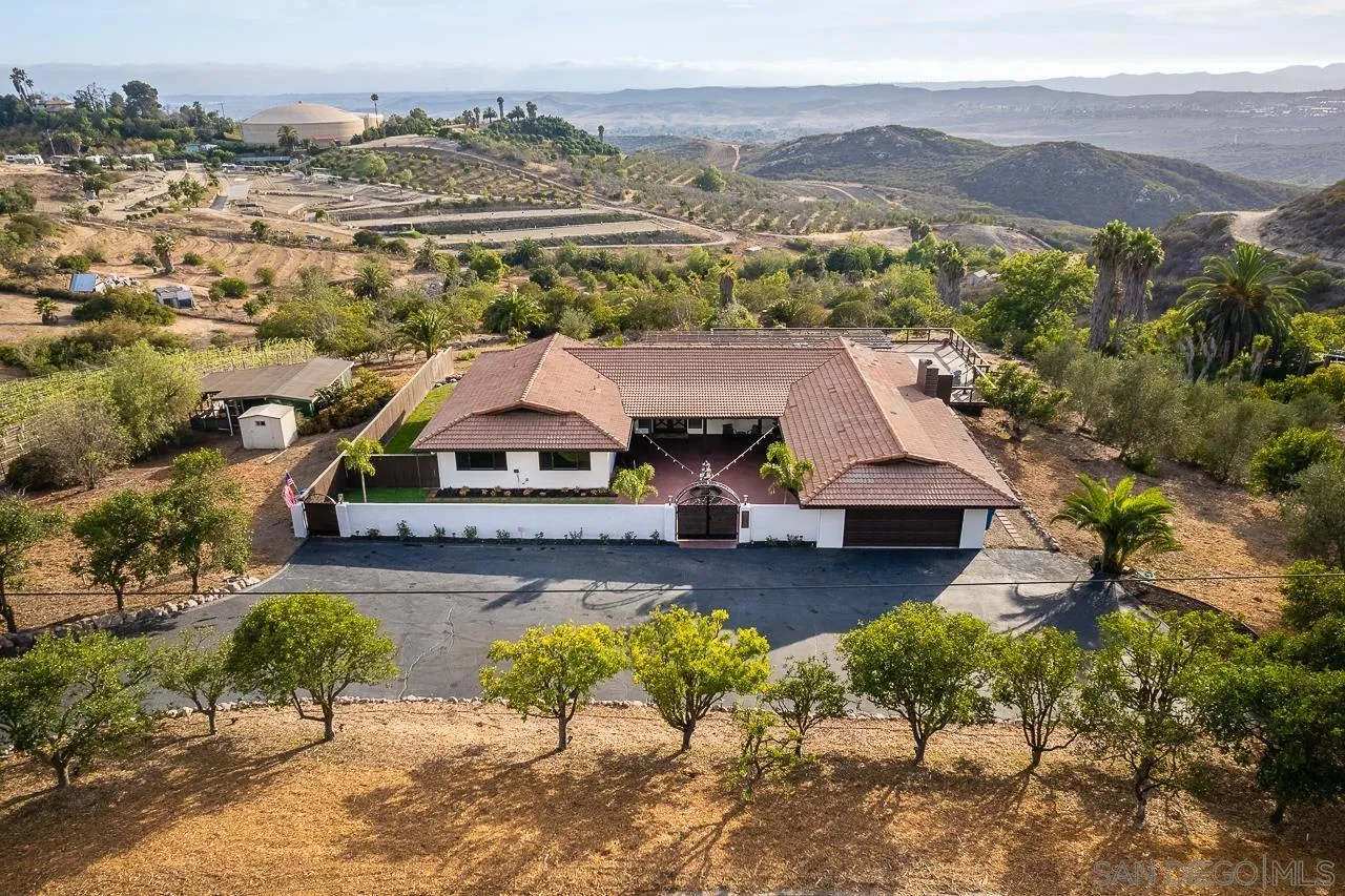 1647 Sleeping Indian Road Fallbrook, CA 92028 - Photo 47 of 48 an aerial view of a house with a garden and lake view