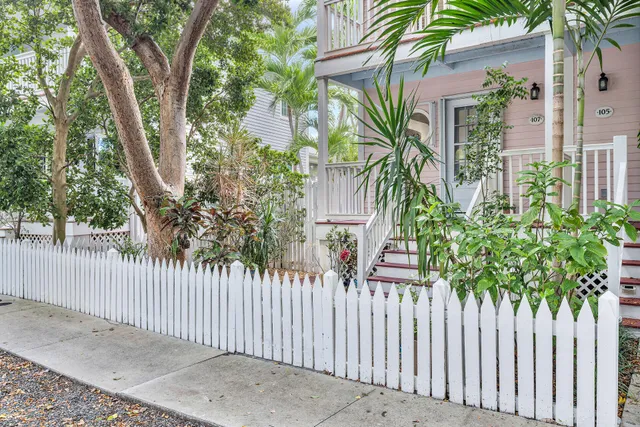 a house that has a tree in front of it