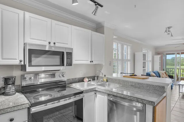 a kitchen with stainless steel appliances granite countertop a sink stove and cabinets