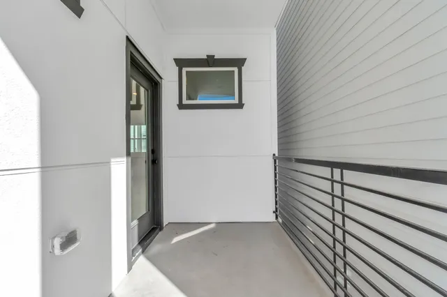 a view of a hallway and wooden floor