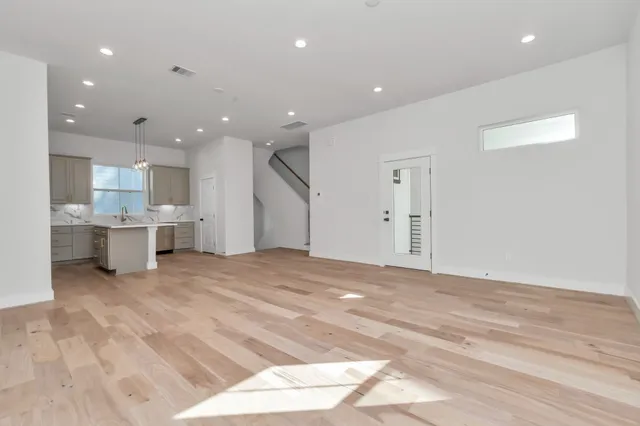 a view of kitchen with kitchen island a sink stainless steel appliances and cabinets