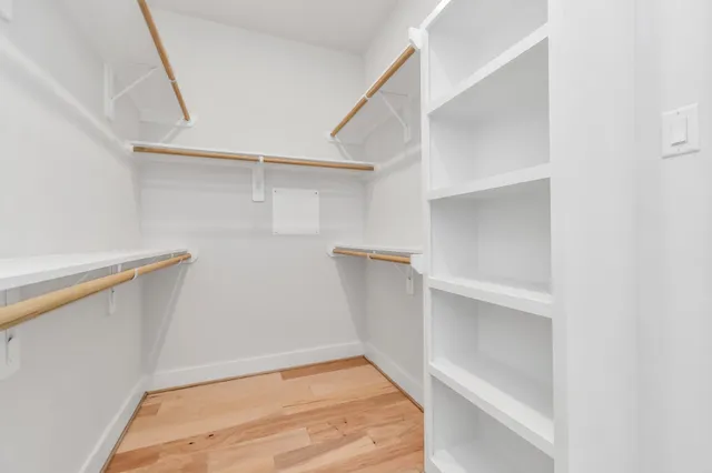a view of walk in closet with empty racks