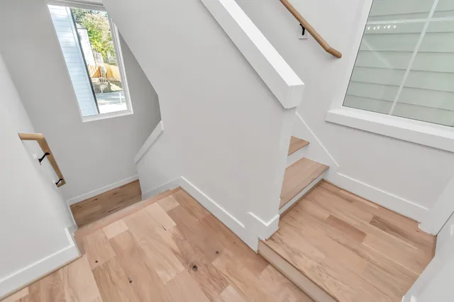 a view of entryway and hall with wooden floor