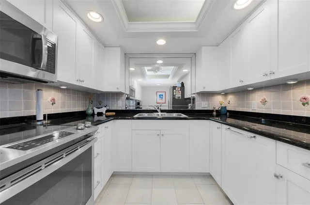 a kitchen with stainless steel appliances granite countertop a sink and cabinets